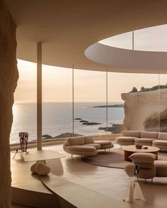 a living room with an ocean view is shown in this modern style house by the sea