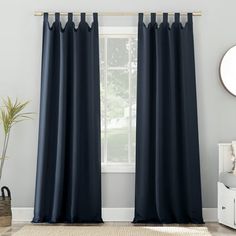 the curtains are blue in color and have black grommets