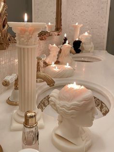 there are candles that are on the bathroom counter