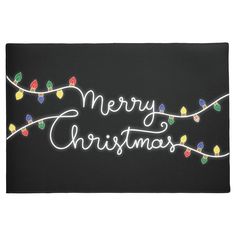 a black door mat with christmas lights on it