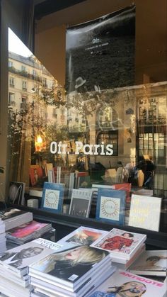 books are on display in the window of a book store