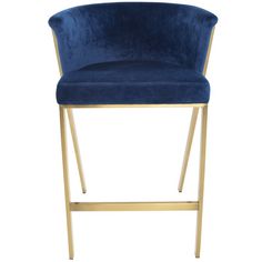 a blue velvet bar stool with gold metal frame and footrests on an isolated white background