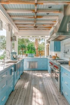 a kitchen with blue cabinets and wooden floors is shown in this image from the inside