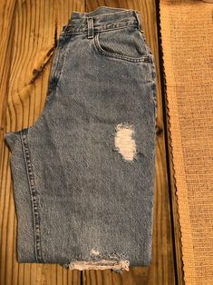 High waisted with distress detail. Lee jeans from the 90s. 90s Style Distressed Relaxed Fit Bottoms, 90s Distressed Relaxed Fit Bottoms, 90s Distressed Bottoms With Relaxed Fit, 90s Style Distressed Bottoms For Fall, 90s Distressed Bottoms For Fall, 90s Style Medium Wash Jeans With Frayed Hem, 90s Ripped Jeans For Streetwear, 90s Distressed Mid-rise Jeans, Acid Wash Ripped High Rise Jeans