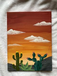 an acrylic painting of a cactus at sunset with clouds in the sky behind it