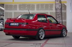 a red car is parked in a garage