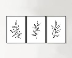 three black and white prints with leaves on them in a minimalist style, hanging on the wall