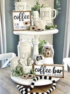 three tiered shelves holding coffee mugs and other items on top of a wooden table