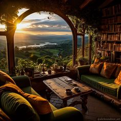 a living room filled with furniture and a large window overlooking the valley in the distance