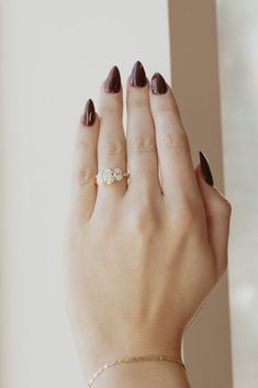 a woman's hand with two rings on it