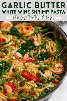 garlic butter white wine shrimp pasta with fresh tomatoes and basil in a skillet on the stove