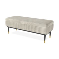 an upholstered bench with wooden legs and a white blanket on the top, in front of a white background