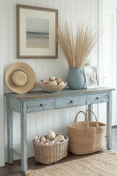 a table with two baskets on top of it next to a basket filled with seashells