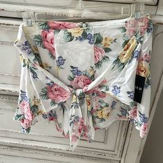 Cute White Floral Shorts From Forever 21 Size Large Has A Zipper On The Back And A Bow/Knot Detail On Front Summer Shorts For Brunch During Beach Season, Floral Print Short Bottoms For Brunch, Short Floral Print Bottoms, Summer Shorts For Beach Season Brunch, Summer Bottoms With Tie Waist For Brunch, Summer Shorts With Tie Waist For Day Out, Summer Style Bottoms With Tie Waist For Brunch, Spring High-waisted Tie Waist Shorts, Trendy Tie Waist Shorts For Summer