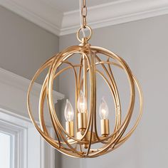 a gold chandelier with three candles in it