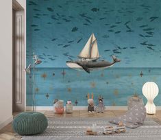 an ocean scene with a boat, whale and seagulls painted on the wall