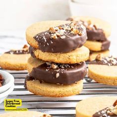 cookies with chocolate frosting and pecans on a cooling rack