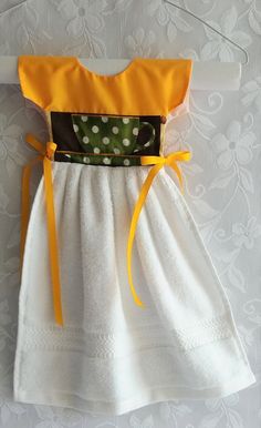 a white and yellow dress with polka dots on it