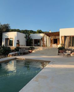 a house with a pool in front of it