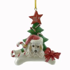 a dog ornament with a christmas tree on it's back and a bone in the foreground