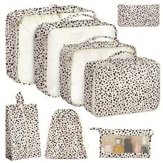 six pieces of white and black polka dot print luggage bags with matching pouches,