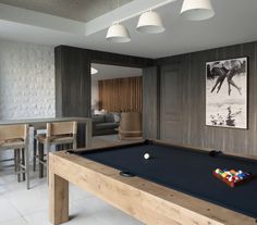 a pool table and some chairs in a room