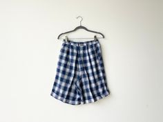 A pair of vintage plaid shorts in blue flannel. High waisted fit with a smocked waistline in back for easy and comfortable fit and a cuff at bottom with button and zipper closure. In great vintage condition with no rips tears or stains. Fabric rayon and linen. Waist26 rise 14 inseam 8 Cream Wool Coat, 90s Flannel, Flannel Shorts, Blue Flannel, Vintage Plaid, Small Photos, Plaid Shorts, Phoenix Az, Embroidered Dress