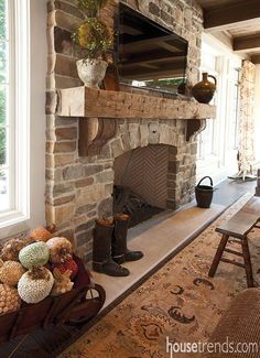 a living room filled with furniture and a fire place