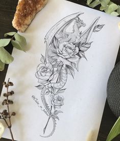 a piece of paper sitting on top of a table next to some flowers and plants