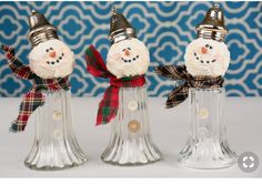 three glass snowmen with hats and scarfs