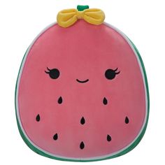 a watermelon shaped pillow with a bow on it's head and eyes