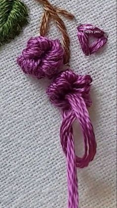 two pieces of purple and green yarn are next to each other