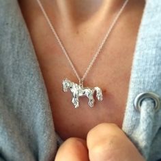 A perfectly shaped little horse pendant, suspended from a fine trace chain. Horses symbolise freedom, travel, movement, and desire. The horse also represents power in Native American tribes. This horse pendant comes on a 1.2mm trace chain which can be worn at 16 or 18 inch length. If you prefer a longer 20/22 inch chain, please add a comment to your order. We can also personalise the pendant with a tiny engraving on the horse's bottom. If you would like us to engrave up to three characters, plea Horse Design Pendant Necklace As Gift, Horse Design Round Pendant Necklace As Gift, Horse Design Round Pendant Necklace For Gift, Round Pendant Necklace With Horse Design For Gift, Unique Horse Design Jewelry Gift, Unique Horse Design Jewelry For Gift, Freedom Travel, Lover Jewelry, Horse Pendant