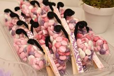 there are many pink and white candies on sticks