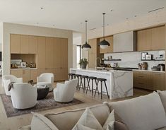 a living room filled with furniture next to a kitchen