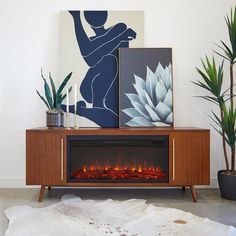 a living room with a fireplace and art on the wall