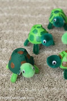 four little turtles made out of paper on the floor