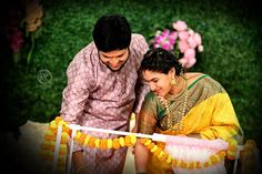 a man and woman cutting a cake together