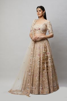 Entirely handcrafted with zardosi and crystal embroidery, this blush pink lehenga is a stunner! Fabric: Pure silk All preorders will be handled by a Nazranaa Bridal Consultant who will virtually discuss measurements and minor changes according to the client's specifications Occasion: Wedding Ceremony or Wedding Reception WASH CARE INSTRUCTIONS - Please Dry clean only when it is applicable. Slight color variation is possible due to digital photography. Jewelry not included Beige Lehenga With Zari Work For Reception, Beige Choli With Resham Embroidery For Reception, Beige Embroidered Choli For Reception, Peach Traditional Wear With Intricate Embroidery For Wedding, Beige Lehenga With Zari Work For Diwali, Beige Lehenga With Resham Embroidery For Diwali, Traditional Beige Lehenga For Reception, Semi-stitched Beige Lehenga With Zari Work, Bollywood Style Embellished Beige Lehenga