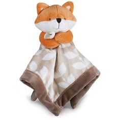 a stuffed fox wrapped in a blanket on top of a white surface with polka dots