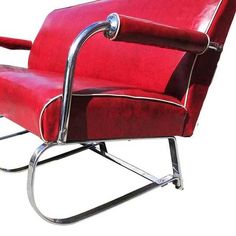 a red chair with chrome frame and footrests on it's legs, sitting in front of a white background