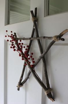 a star made out of sticks with berries on it