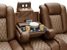 the seats in this home theater are full of snacks and drinks, along with popcorn