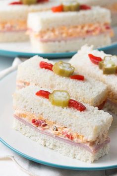 two plates with sandwiches on them sitting on a table