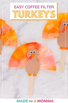 an easy coffee filter turkey craft made with popsicles and paper plates to make it look like a turkey