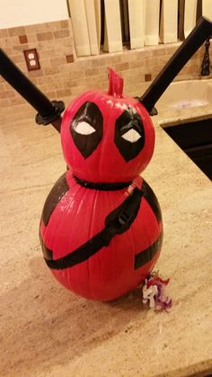 a deadpool pumpkin sitting on top of a kitchen counter