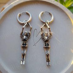 Stunning punk/goth style skeleton huggie hoop earrings in silver! 💀  The hoops and skeleton pendants on these earrings are made of high quality stainless steel so are hypoallergenic and won't tarnish or discolour. Unisex. Available as a single earring or as a pair. Hoops measure: 17mm Skeletons measure 40mm Please don't hesitate to contact me with any queries or suggestions 😊  Comes gift wrapped 🖤 Gothic Pierced Jewelry For Streetwear, Emo Streetwear Jewelry For Halloween, Gothic Metal Earrings For Streetwear, Nickel Free Gothic Jewelry For Streetwear, Gothic Nickel Free Jewelry For Streetwear, Punk Pierced Hoop Earrings For Streetwear, Handmade Punk Hoop Earrings, Gothic Silver Earrings For Streetwear, Gothic Hoop Cartilage Earrings