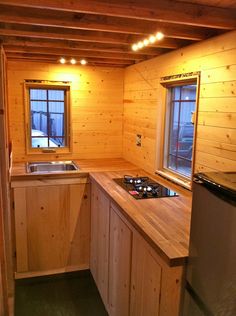 a kitchen with wooden walls and counter tops