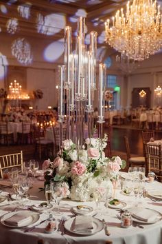 the centerpieces in this elegant wedding reception are tall