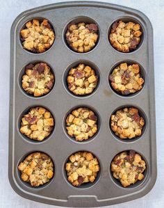 a muffin tin filled with lots of different types of baked goods on top of it